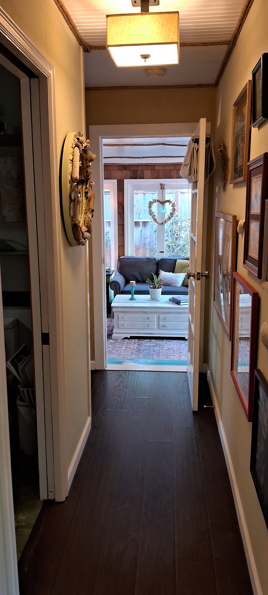 Hallway leading from the primary ensuite bedroom, out to the sunroom/ family room
