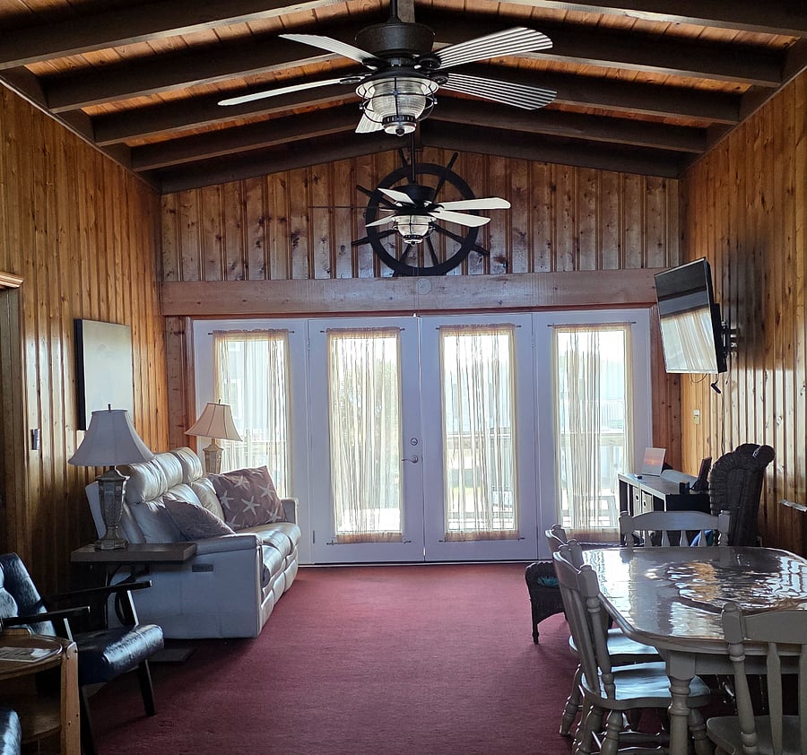 Comfortable living room with smart tv, reclining sofa, charging ports.