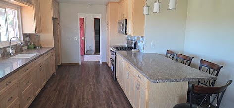 large kitchen with gas stove, microwave, blender, coffee maker