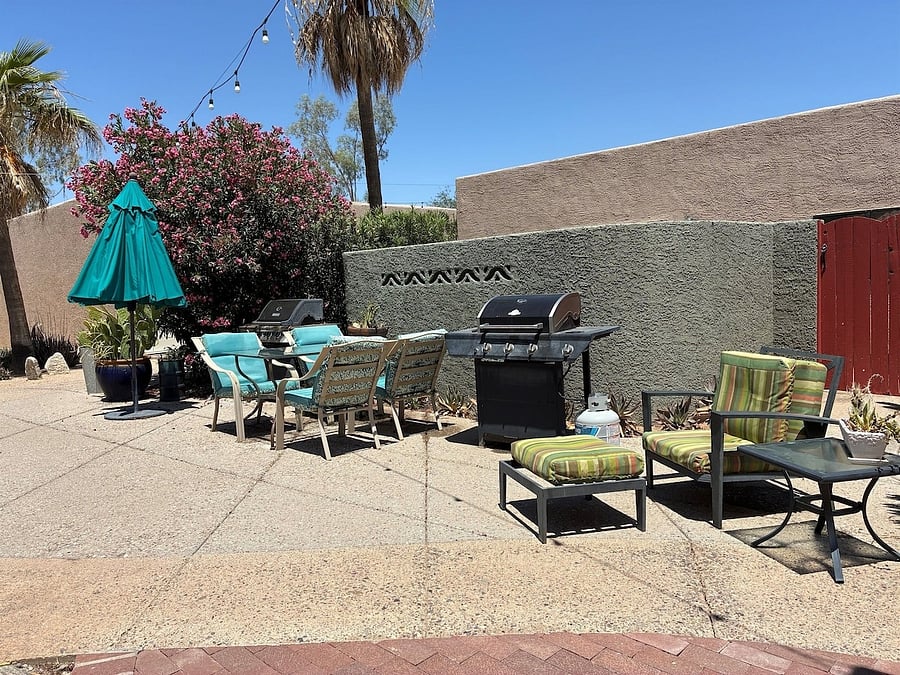 Two grills near pool area.