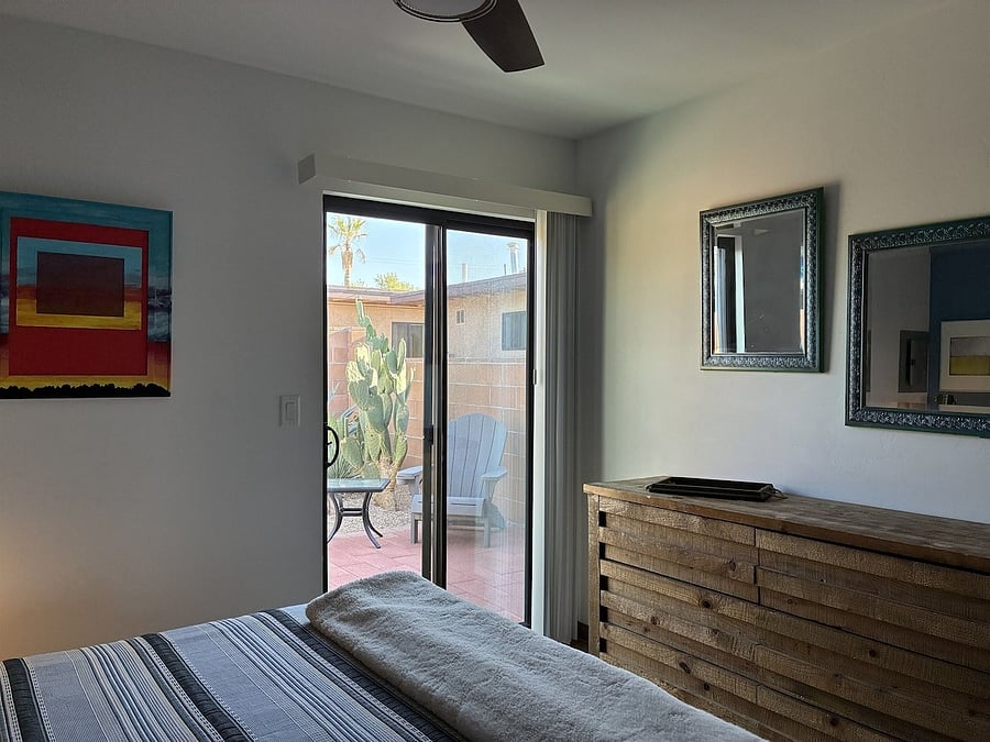 Sliding glass window leading to walled in back yard.