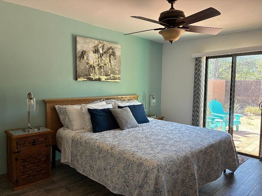 Bedroom, king bed, sliding door leads to walled and fenced backyard.