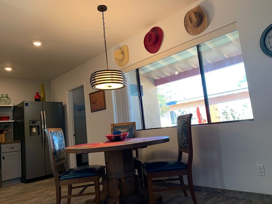 Dining area next to kitchen, laundry room is door next to refrigerator.