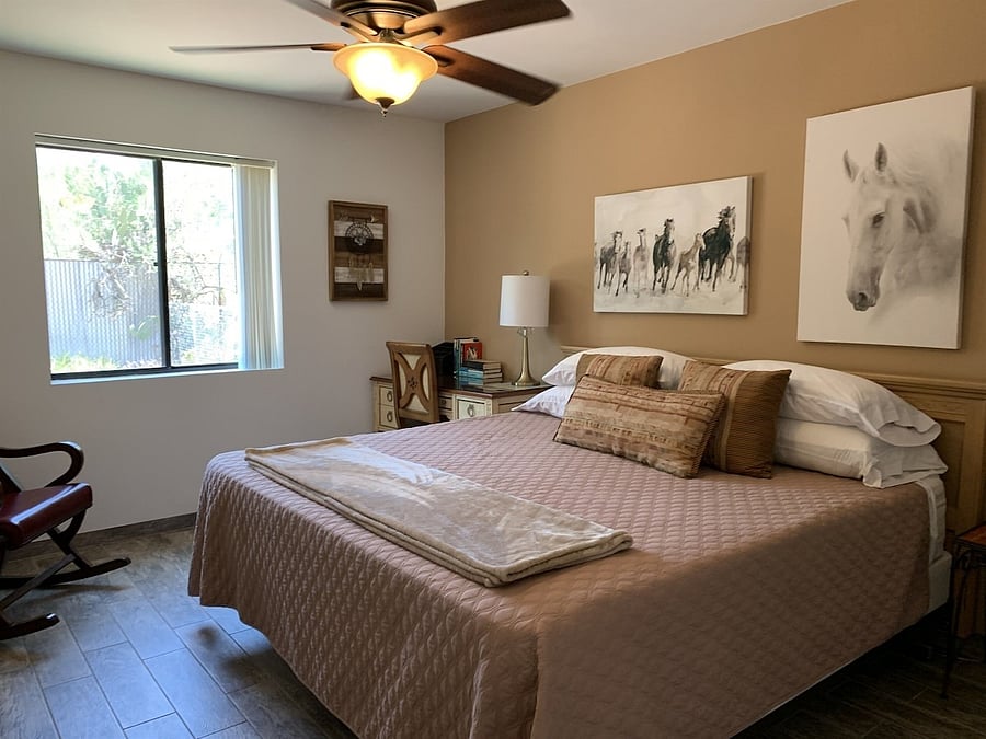 Second bedroom with king bed and desk in corner.