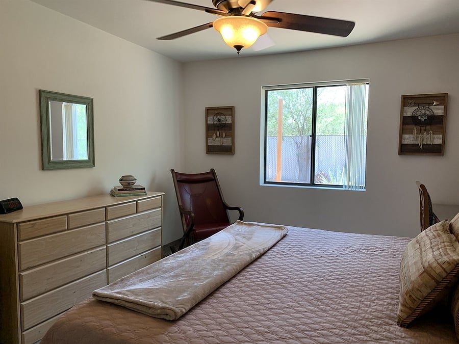 Second bedroom, window looks out to fenced in back yard.