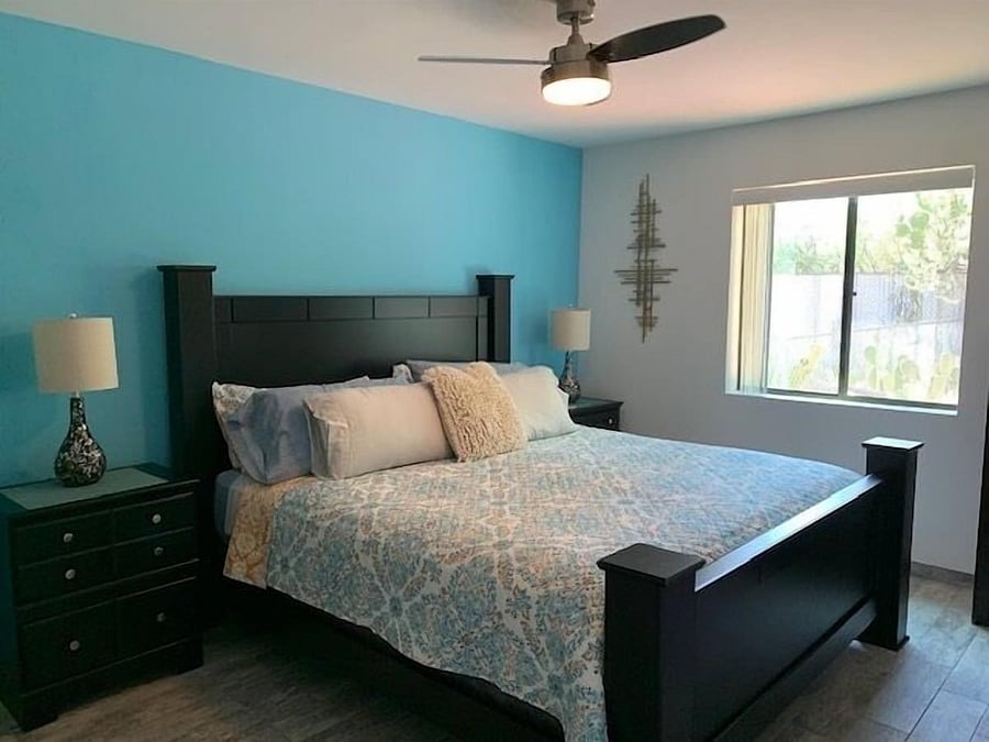 Bedroom with king bed, window look over backyard.
