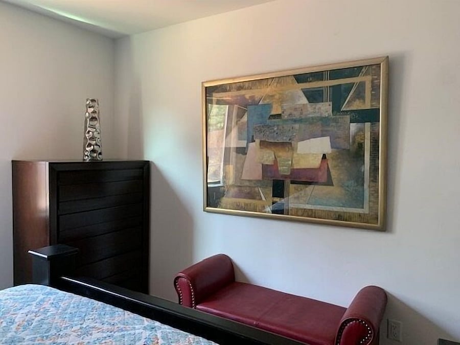 Bedroom with bench and dresser.