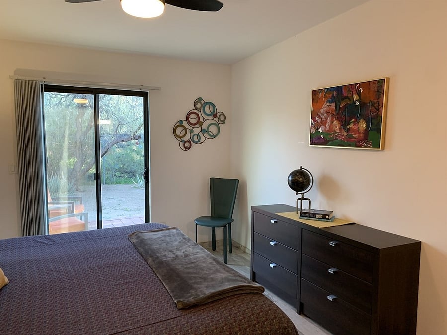 Sliding glass door leading to fenced backyard area.Bedroom.