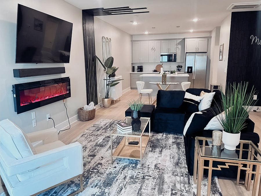 Spacious open layout with electric fireplace and designer furnishings