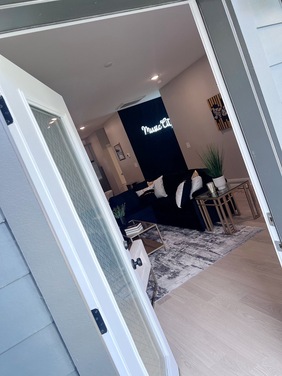 Step into the modern open-concept living space from your balcony, complete with designer furnishings and a welcoming Music City vibe.