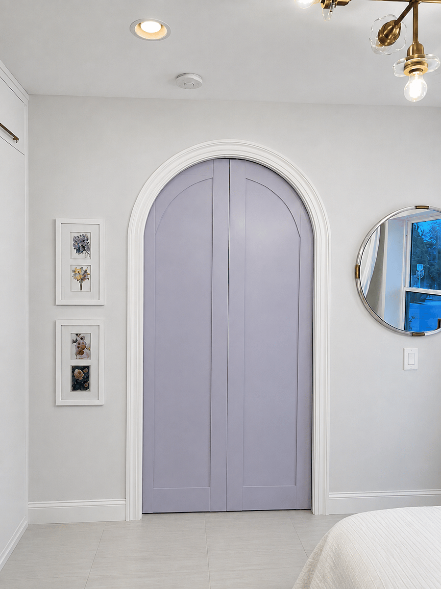 Custom arched doors add a whimsical architectural focal point in the bedroom (the living room side is white).