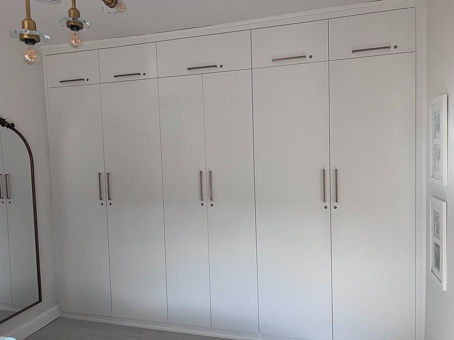 Exceptional storage for a home of this size: Floor-to-ceiling custom closets in the bedroom keep the bedroom streamlined, organized, and beautifully uncluttered.