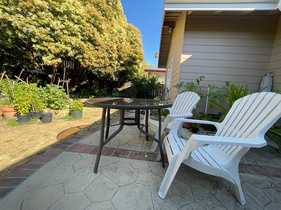 access to backyard with lush garden