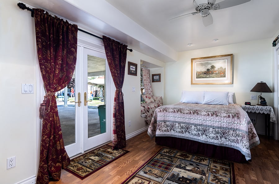 Downstairs bedroom with queen bed off the carport