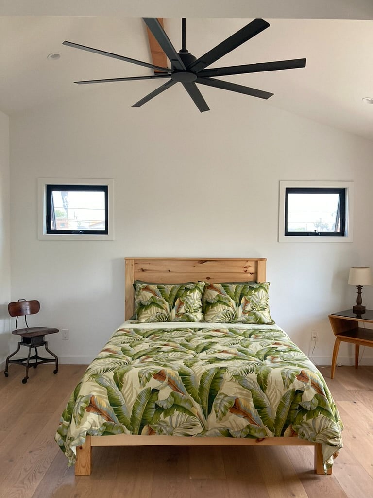 Bedroom with Queen Bed and ceiling fan along with plenty of light.