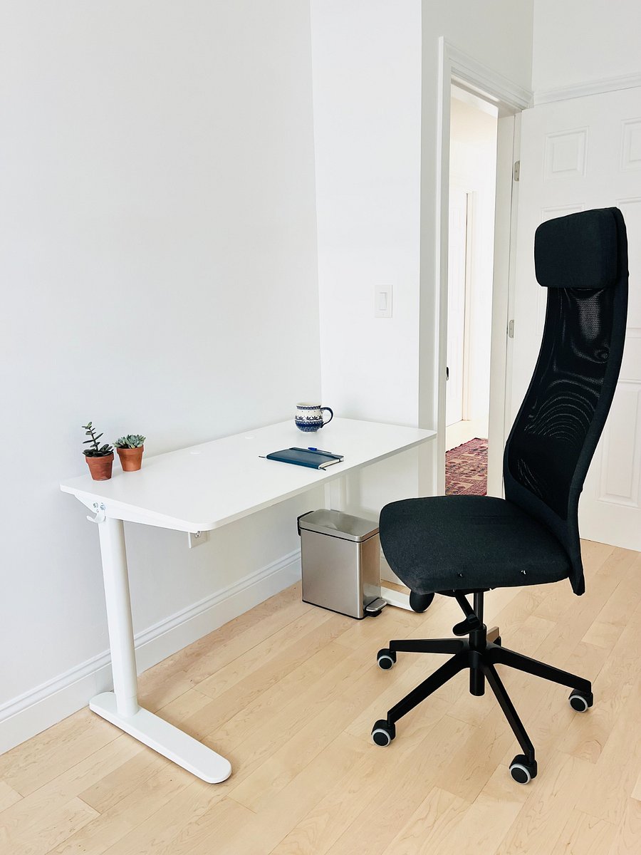 Second bedroom contains a standing desk, futon, and closets