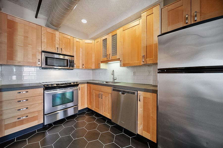 Kitchen with Newly Remodeled Tile Floors and Stainless Steel Appliances