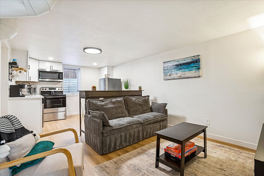 The living room and kitchen are designed in an open-concept style, creating a seamless and spacious area.