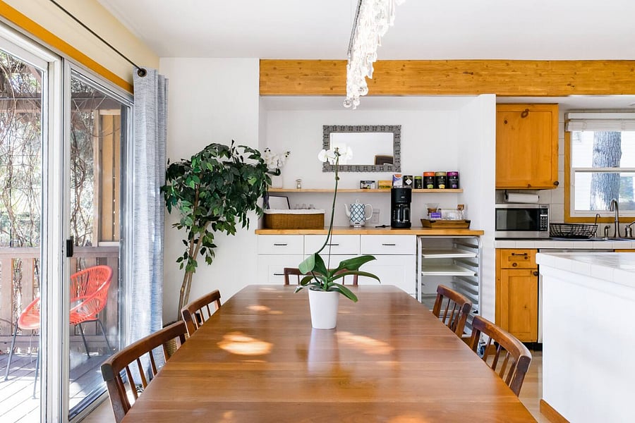Dining area opens to private fenced in yard with deck