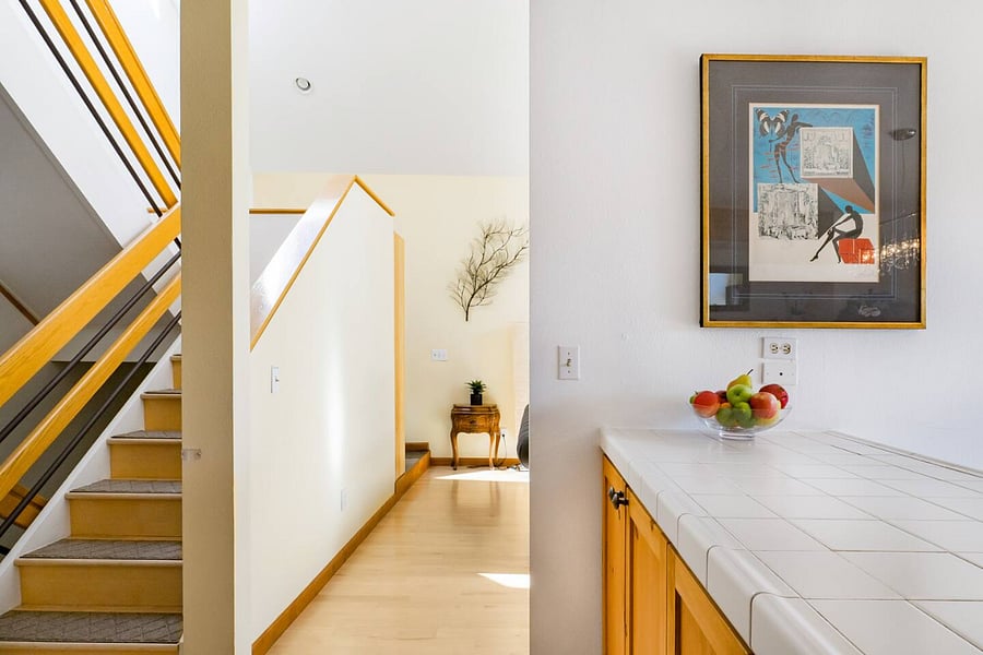 Open layout of kitchen leading into primary living room