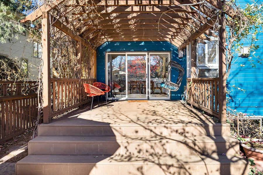 Pergola covered deck area with sliding door access into the kitchen and dining area