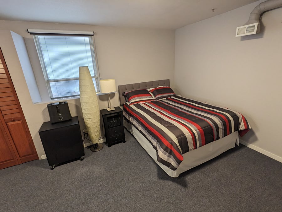 Upper-level suite queen bed.