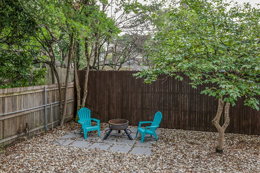 Backyard is hardscaped and has a grass area. Also a fire pit and wood is available.