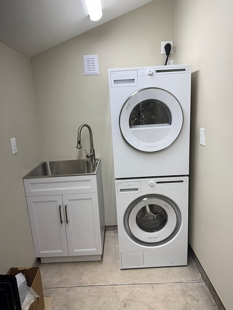 Laundry sink on left.
Stacked Washer and Electric Dryer
Space to store a bike.
