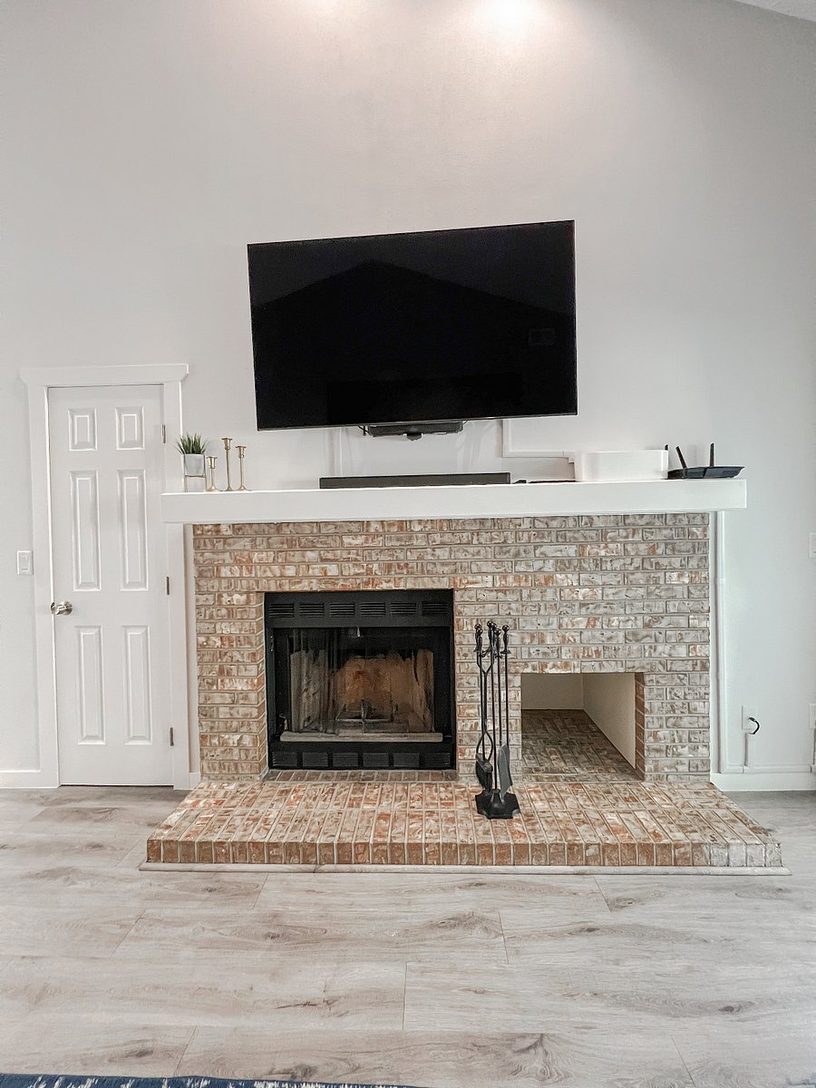 Large flat screen TV and a wood-burning fireplace