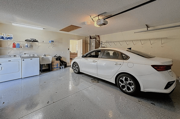 2 car garage with washer and dryer open to outside patio