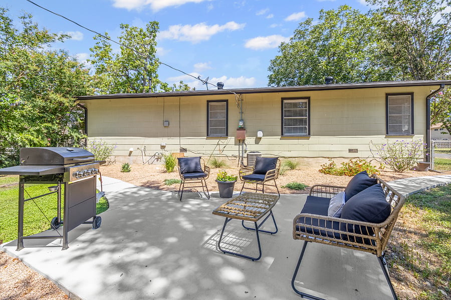 Outdoor seating and grill for evening unwinding.