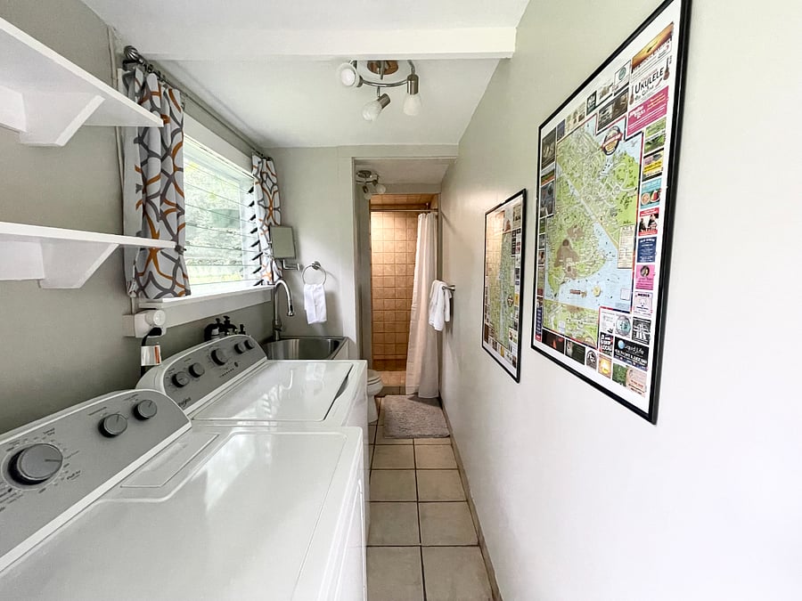 This laundry bathroom combo is connected to the carport and features a walk-in shower.