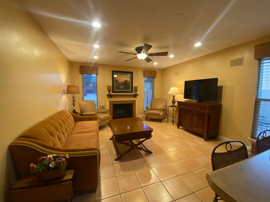 Recliners and couch make for comfortable and relaxing family room. Wooden slat shutters for privacy.