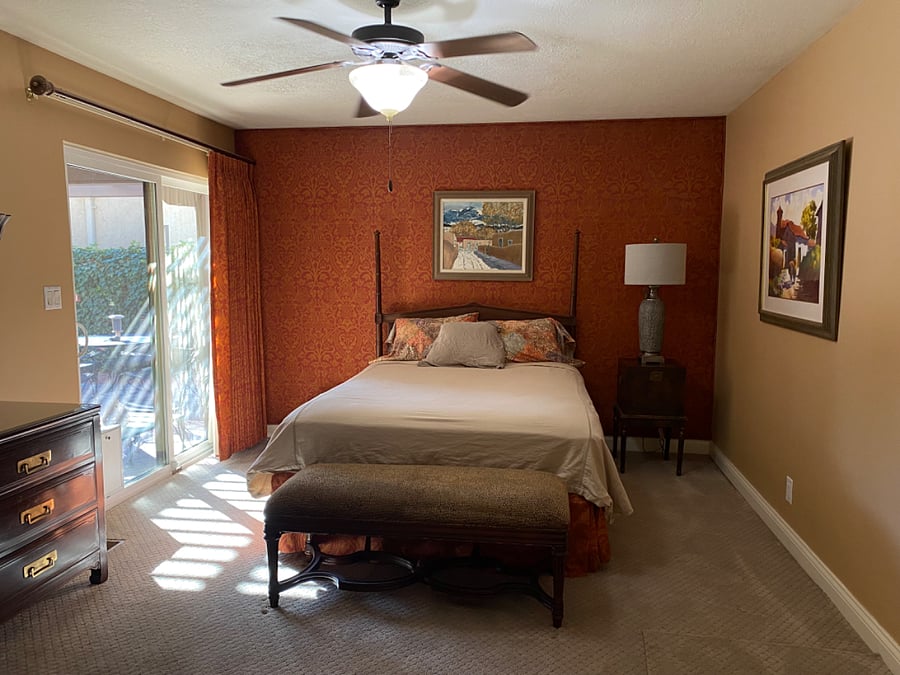 Master Bedroom has sliding glass door direct to the covered porch area. Queen bedroom set. Smart TV mounted on wall.