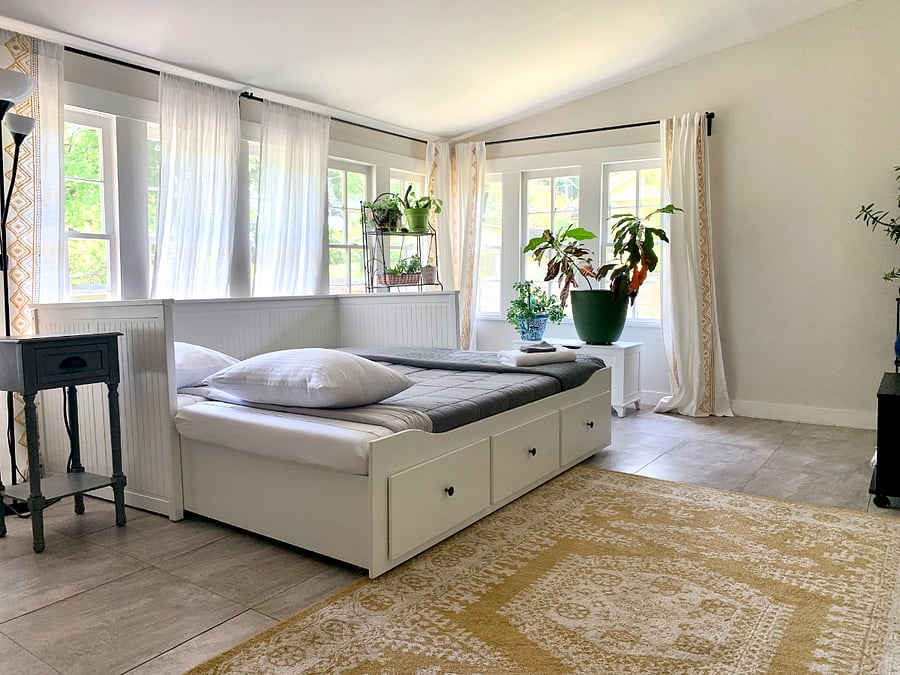 bright sunroom with daybed that pulls out to a full bed for when guests stay over.
