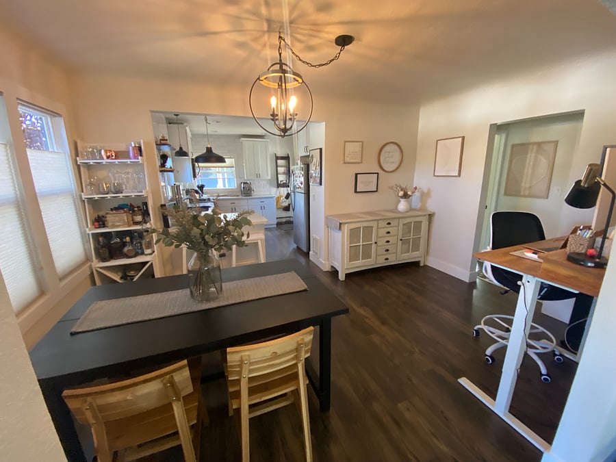 Looking into dining area, workspace, and hallway to bedrooms.