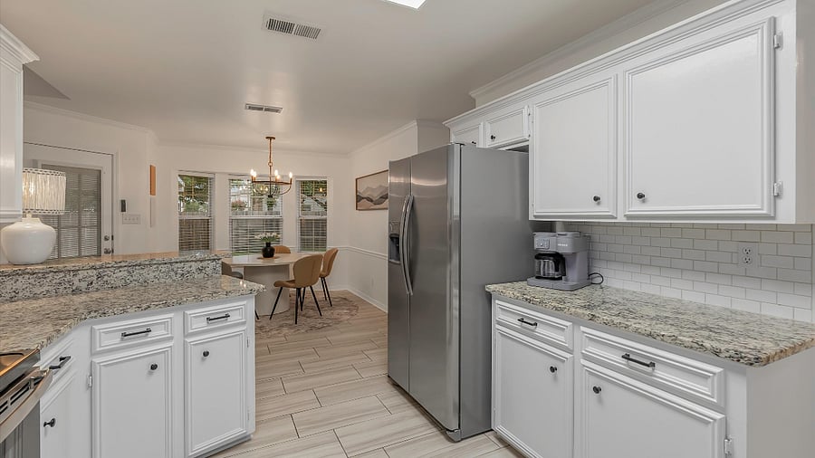 Stocked Kitchen with bar stools, appliances and larges cabinets