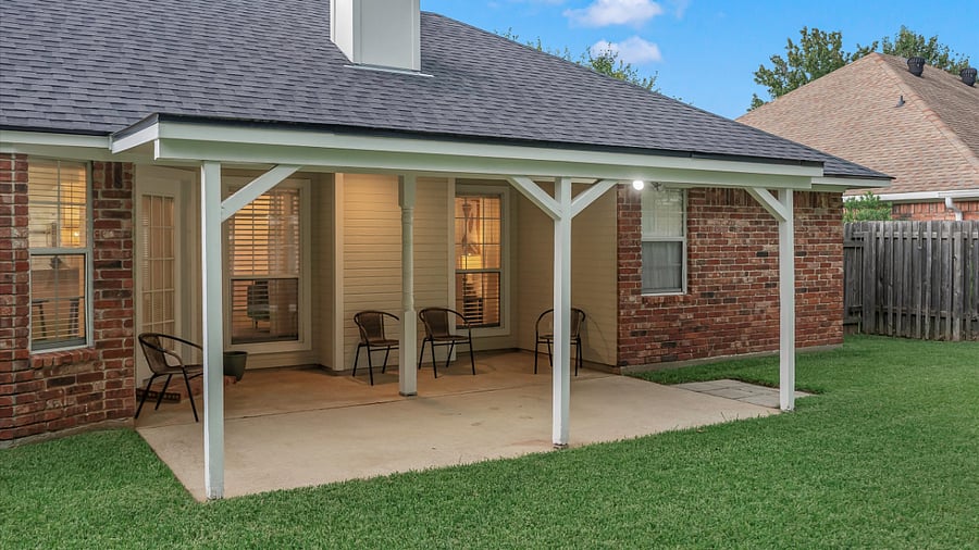 Covered back patio with seating area, fan & lights