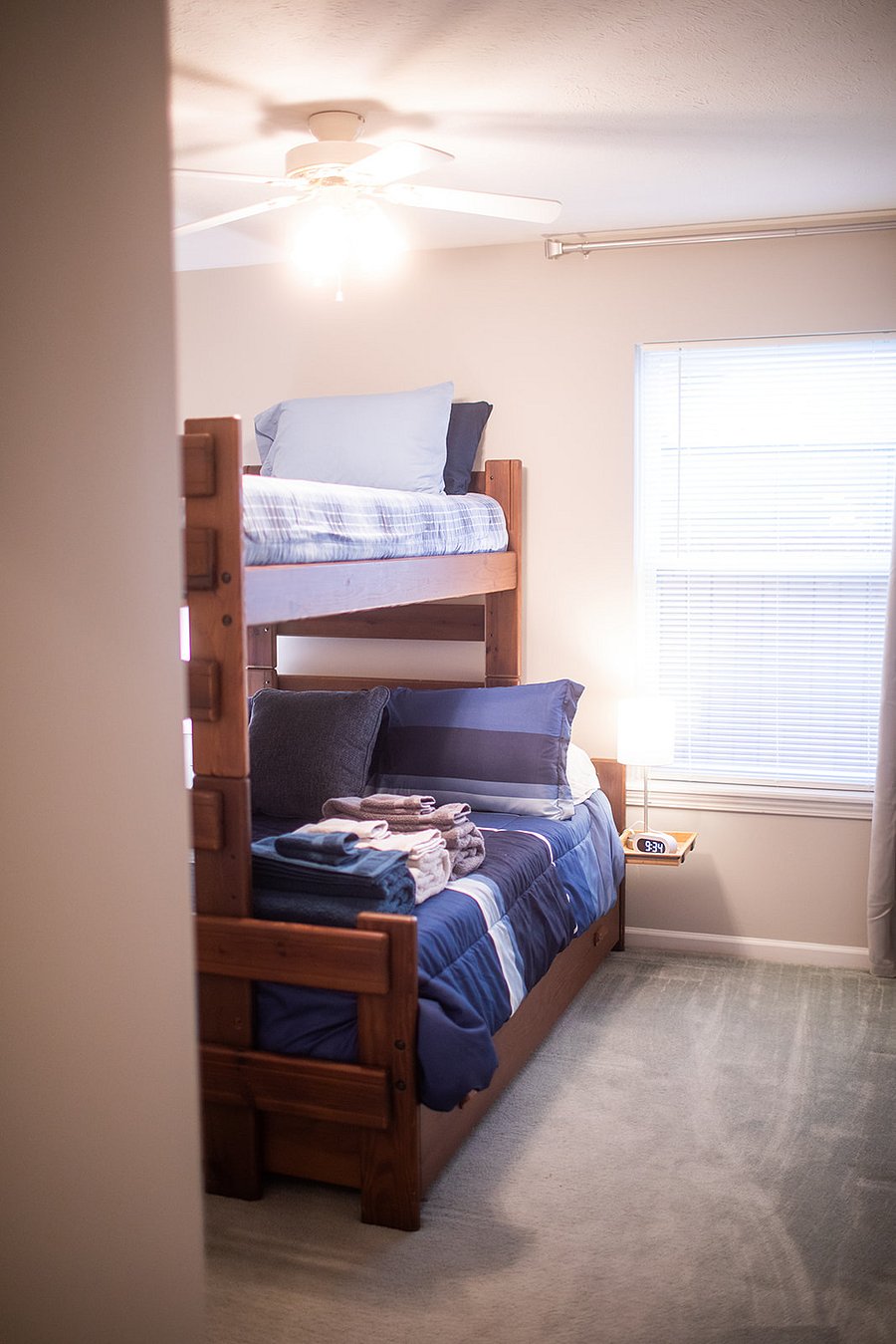 Bunk room has full (lower) bunk, twin (upper) bunk, and also a twin trundle below; hooks for hanging towels, closet, and a luggage rack