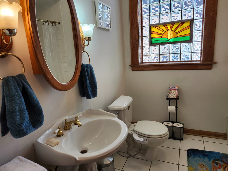 Roomy hall bath on 2nd floor has tub/shower, big sink, storage closet, tile floor, ventilation window, medicine cabinet, plenty of hooks.