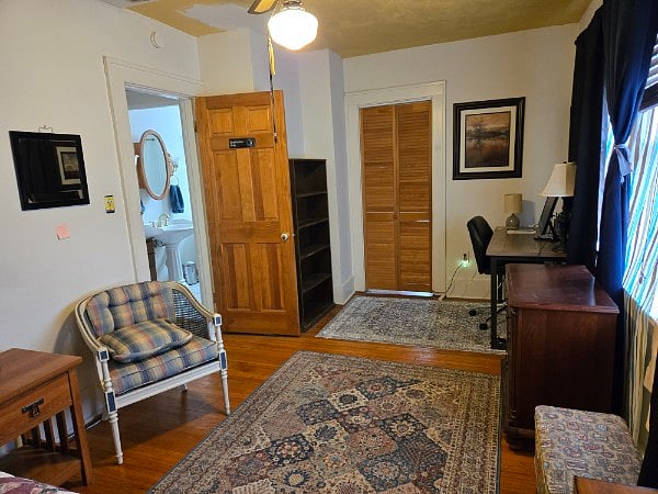 Second bedroom has full-size bed, workstation, closet, shelves, dresser, TV stand, blackout curtains, full-length mirror, lamps, 3-prong outlets. Windows overlook the back yard. Full bath is down the hall. This house has 2 full and 2 half baths! Room dimensions 17 ft 7 inches X 9 ft 5 inches (circa 166 sq feet)