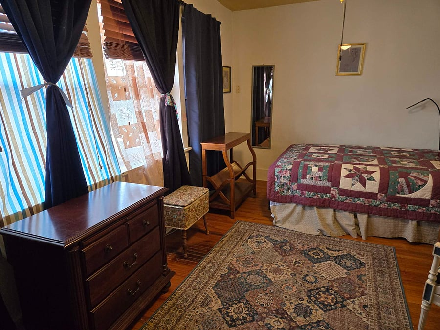 Second bedroom has full-size bed, workstation, closet, shelves, dresser, TV stand, blackout curtains, full-length mirror, lamps, 3-prong outlets. Windows overlook the back yard. Full bath is down the hall. This house has 2 full and 2 half baths! Room dimensions 17 ft 7 inches X 9 ft 5 inches (circa 166 sq feet)