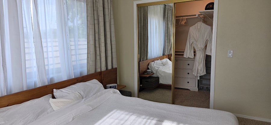 Bedroom: large walk-in closet with three-drawer dresser and lots of storage