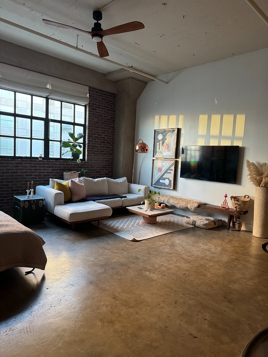 View from the kitchen of living room and bed in the left hand corner 