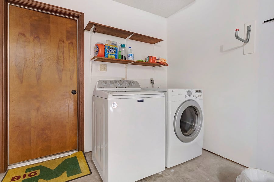 Laundry area located in 2 car garage