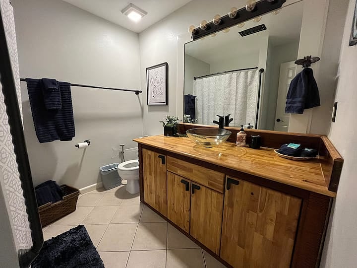 Apt A guest bathroom has tub/ shower combo
