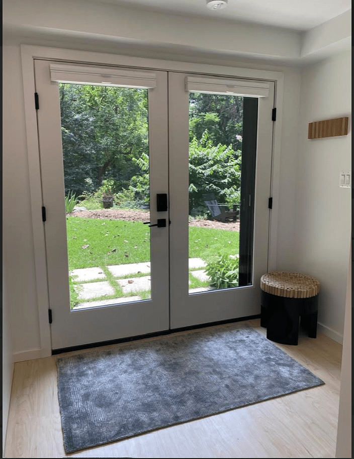 View of Private Entrance Overlooking Garden. Doors Outfitted with Custom Top Down/Bottom Up Floor to Ceiling Shades.