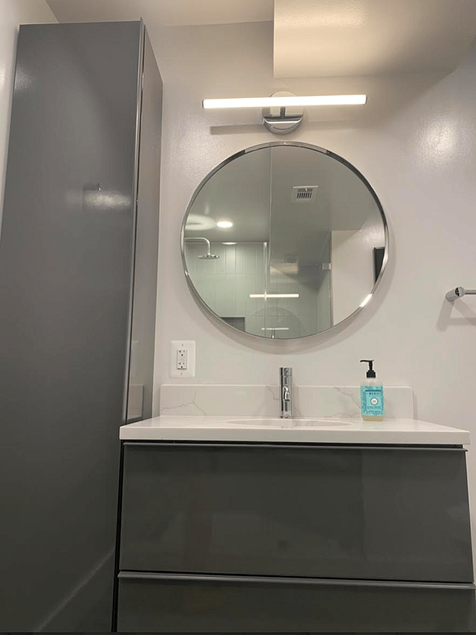 Floor to Ceiling Storage Tower and 2-Drawer Vanity with Custom Quartzite Top.