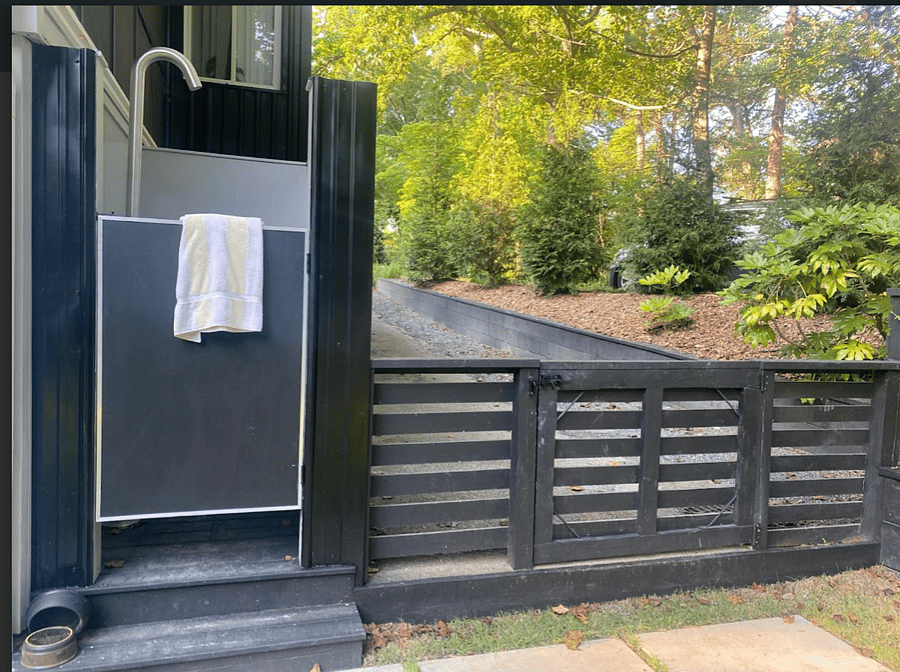 View of Tree-Lined Driveway and Outdoor Shower.