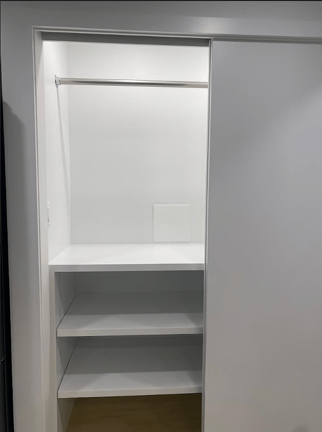 Double Floor to Ceiling Closet with Moveable Shelves, a Hanging Rack, and Interior Lighting.